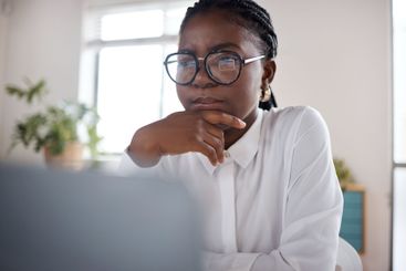 African businesswoman, thinking or accountant on laptop...