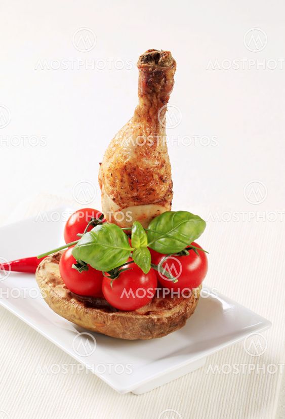 Roasted chicken drumstick and baked potato
