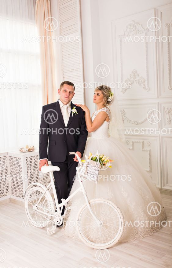 Wedding couple indoors is hugging each other. Beauty...
