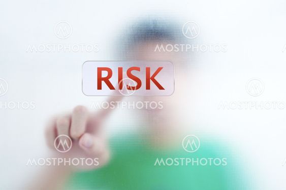 Businessman point finger on RISK wording