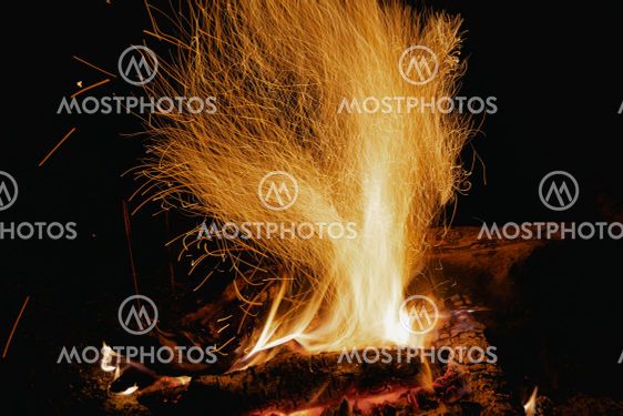 Sparks from fire in dark. Tourist night bonfire.