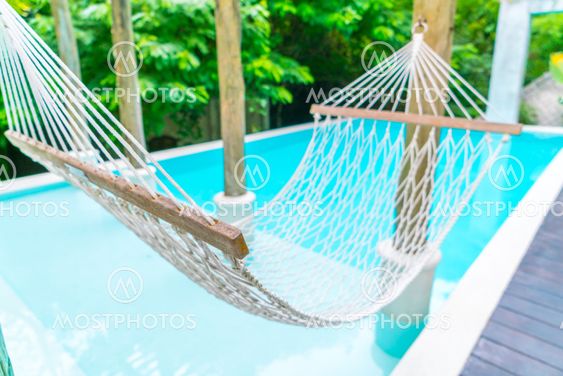 White hammocks in Luxury swimming pool .