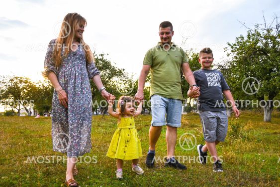 Happy family enjoying in park. Cute Portrait of Happy...