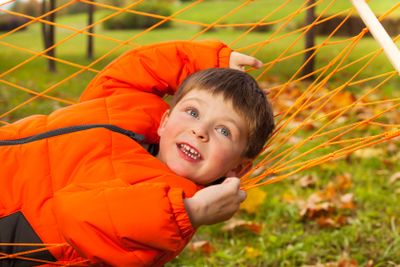 Close up view of happy boy laying on  hammock