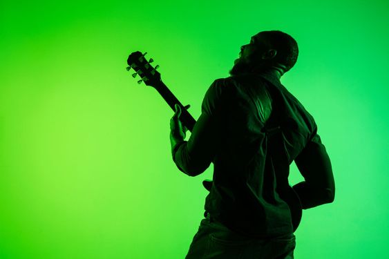 Young african-american jazz musician playing the guitar