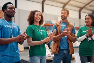 Volunteer teamwork, people and celebration with applause...