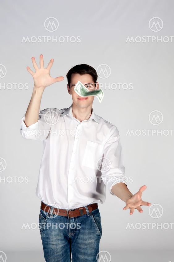 young man catches dollar