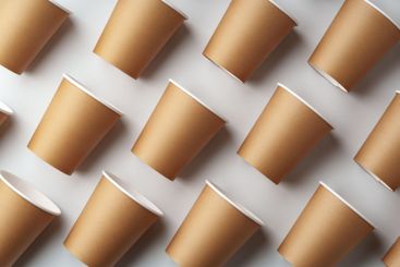 A collection of disposable paper cups arranged in a...