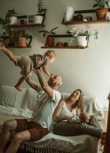 Parents, kids and a family playing on the sofa in the...
