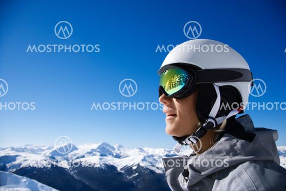Boy snowboarder in mountains.