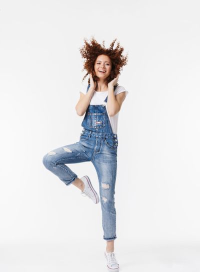 Full length of a cheerful young redhead curly girl