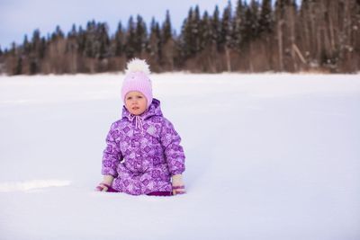 Little girl in snow winter sunny day