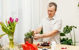 A man prepares a birthday cake for valentine's day and...