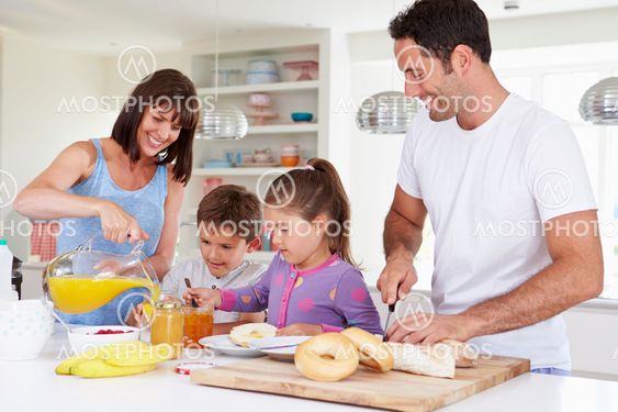 Family Making Breakfast In Kitchen Together