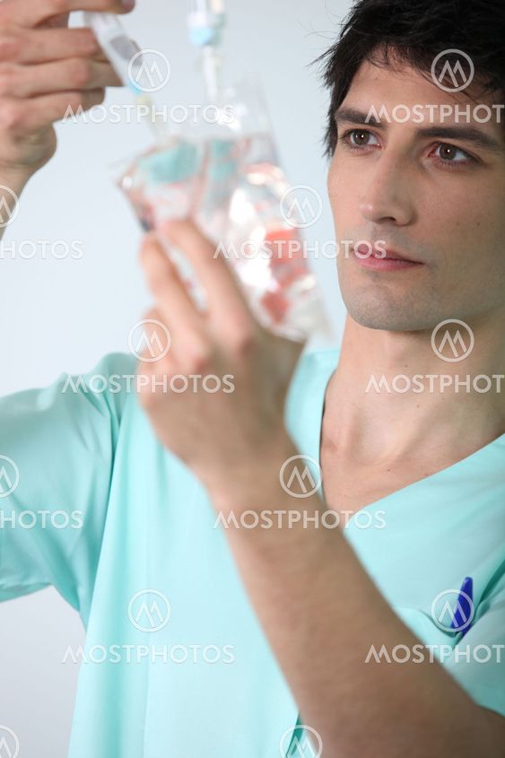 Nurse preparing drip.
