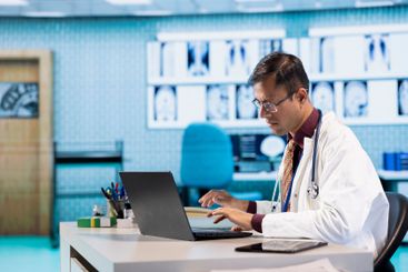 Young physician expert reviewing x ray scan results in...