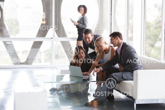 Attractive group of young people collaborating on an idea ina modern office