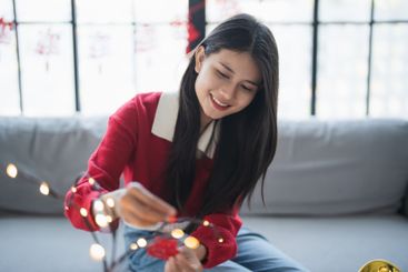 Asian Woman decorated house for Chinese New Year...