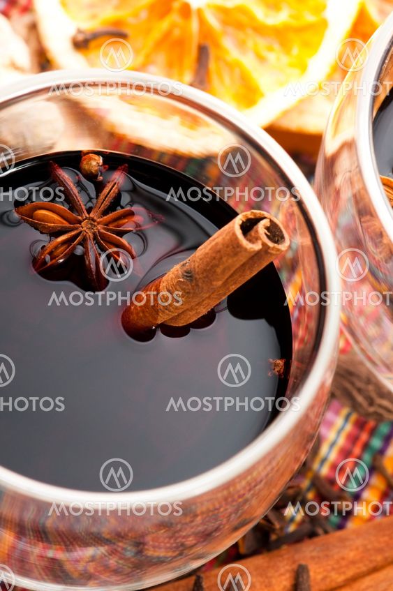 Mulled wine with slice of orange and spices.