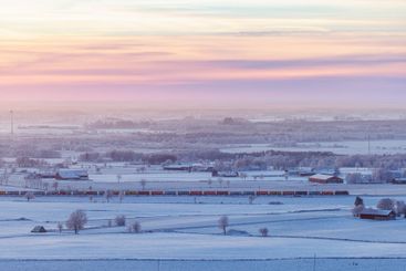 Train in a wintry landscape at dusk