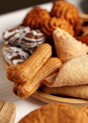 Assorted traditional pastries displayed on a wooden...