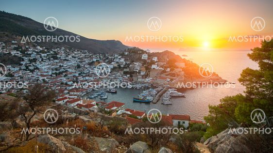 Panoramic views of the marina at Hydra island during sunset Aegean sea, Greece.