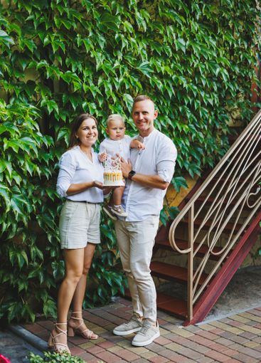 Mom and dad in nature with their one-year-old son...