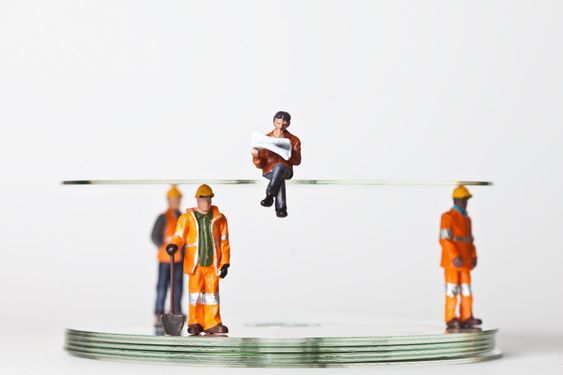 Miniature people in action with CDs
