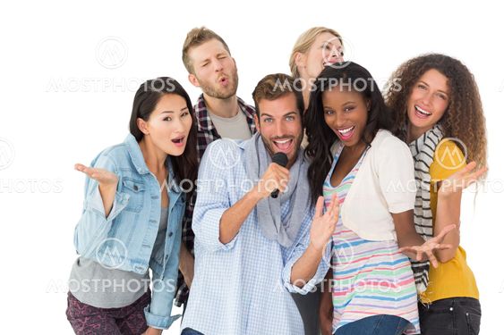 Happy group of friends having fun doing karaoke