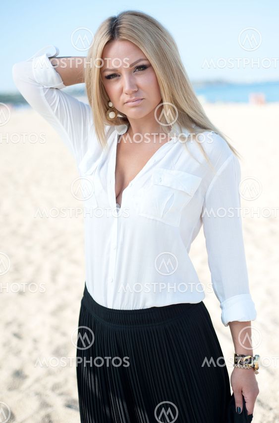 The beautiful young girl plays with hair