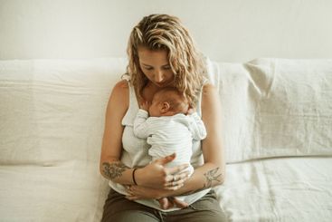 Mother, baby hug and living room in a home with parent...