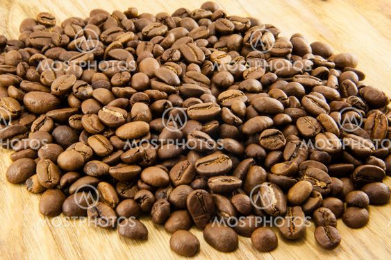 Coffee beans on vintage wooden board