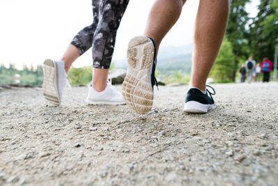 Legs of unrecognizable running couple in sports shoes