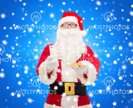 santa claus with glass of milk and cookies