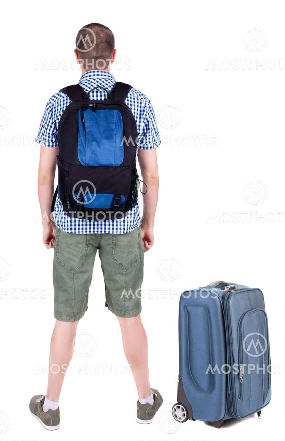 Back view of young man traveling with suitcas.