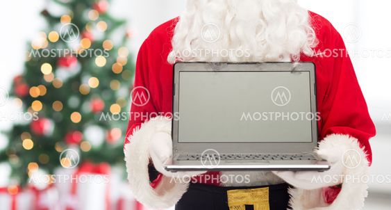 close up of santa claus with laptop