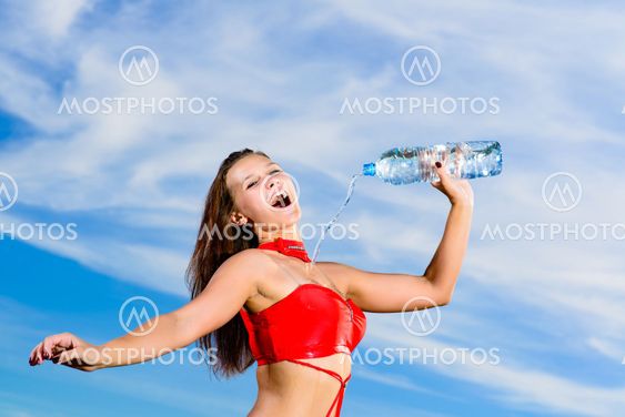 sport girl in red uniform with a bottle of water
