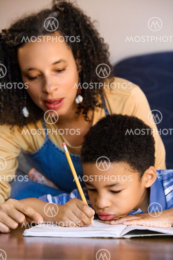 Mother helping son do homework.