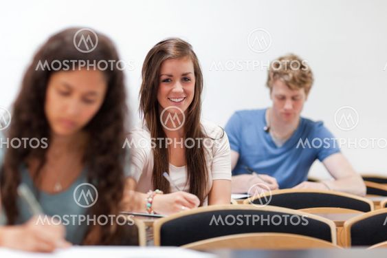 Smiling young students sitting on a chair