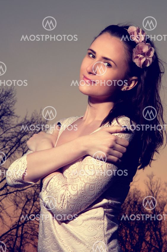 Beautiful woman in light pink dress with flowers