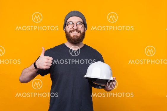 Photo of cheerful bearded man showing thumb up and...