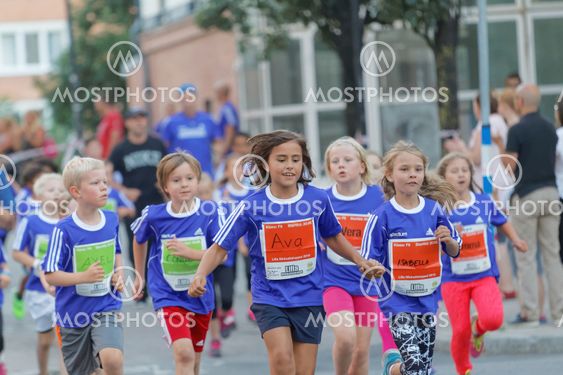 Group of smiling girls and boys running