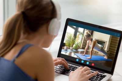 Millennial girl watch yoga training on laptop online