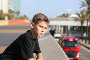 Handsome teenager standing with skateboard. Adolescent...