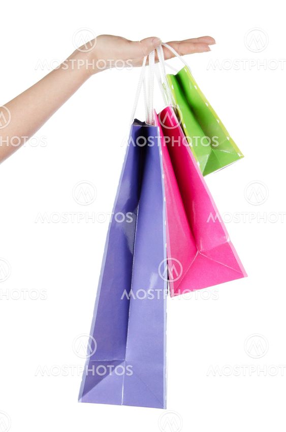 bright gift bags in hand isolated on white