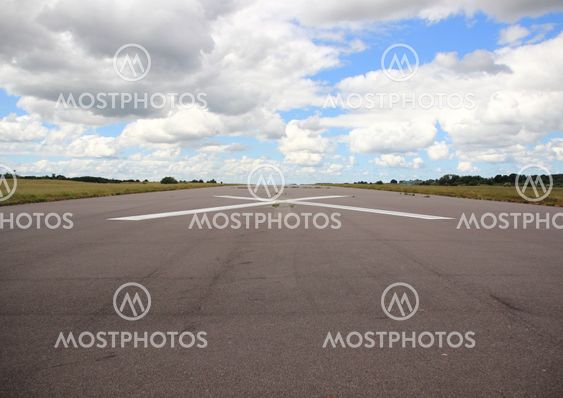 Empty airplane runway with white cross