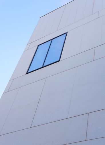 Building, glass window and architecture with blue sky in...