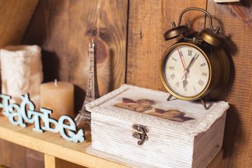Vintage decor with wooden shelf, antique clock, and...