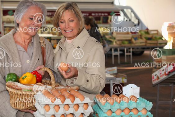 two senior women shopping on the market