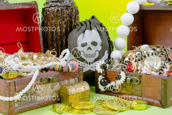 two small boxes with treasures on a light green background